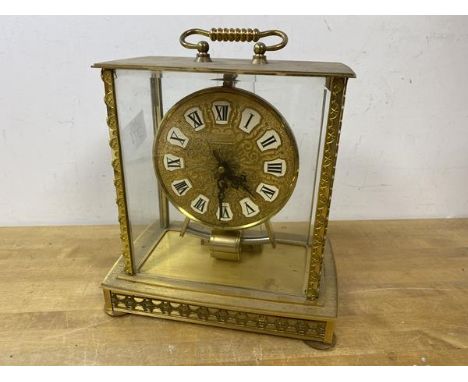 A Japanese Kundo mantel clock, glass to all four sides, gilt metal frame and dial with roman numerals, measures 23cm x 19cm x