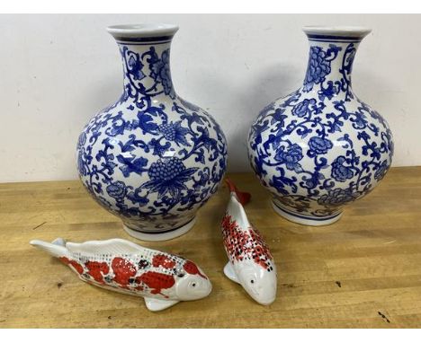 A pair of modern Chinese vases of bulbous form, foliate blue and white pattern, blue seal marks to base, measures 33cm high, 