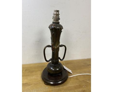 An Art Nouveau metal table lamp with later fixtures of naturalistic form with two handles to side on wooden base, measures 36