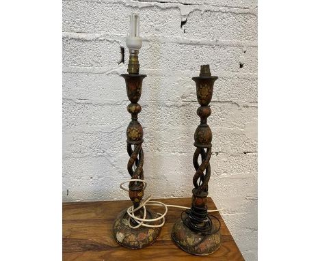 A pair of kashmiri spiral stem ebonised and floral painted table lamps, likely converted from candlesticks, each measures 54c