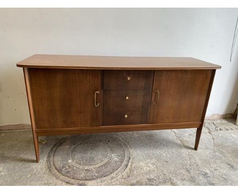 A Vanson sideboard, the shaped rectangular top with moulded edge, central bank of three drawers, top fitted flanked by two cu