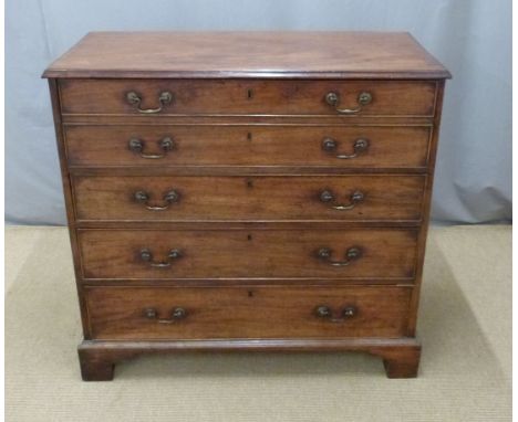 A late 18th/ early 19thC mahogany secretaire chest with fold down flap revealing a fitted interior over three graduated drawe