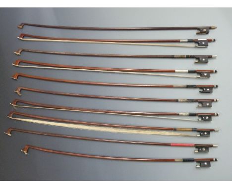 Eight round stick violin bows with various button types, together with two octagonal bows, all with Parisian type eyes to fro