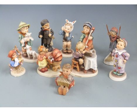 A collection of Goebel Hummel figures including Skier, Cello Player etc