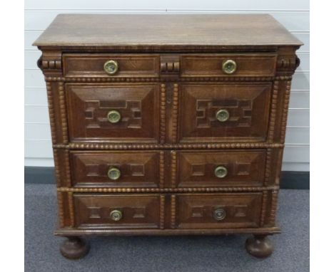 17th/18thC oak chest of four straight drawers of varying sizes with panelled and bobbin decoration raised on bun feet, W97 x 
