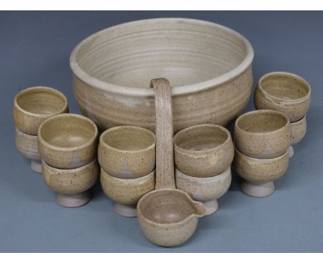 A Studio pottery punch bowl with twelve goblets and a ladle, H17cm, diameter 32cm and a slipware bowl by Prestbury Pottery