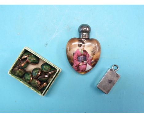 An early 19th century white metal pendant pill box, with engine-turned detail, a silver-mounted porcelain scent bottle, heart