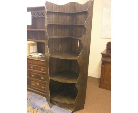 A dark oak corner-fitting shelf unit, six fitted shelves, 6ft. 6in. high