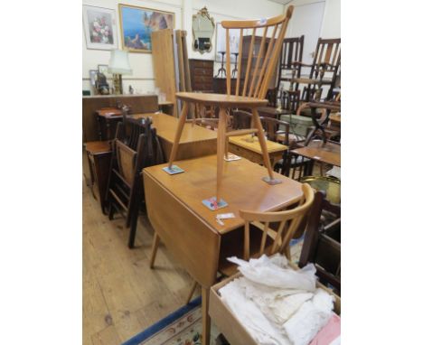 An Ercol light elm drop-leaf dining table, 2ft. 5in., and a pair of stick-back chairs en-suite, clean