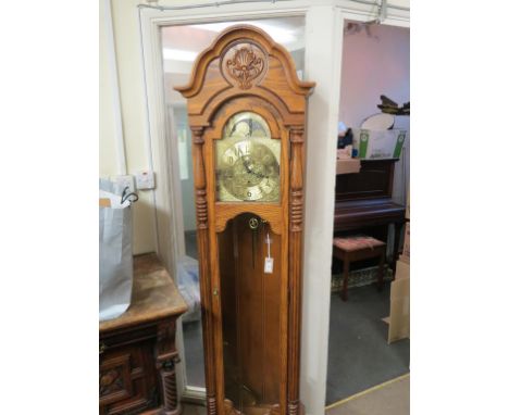 A modern, period-style oak longcase clock, arched dial with moon-phases and subsidiary seconds, movement chiming on rod-gongs