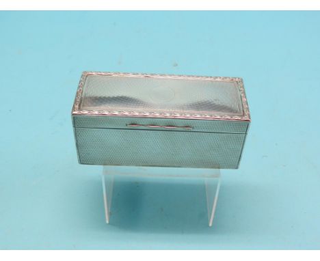 An engine-turned silver jewellery casket, with hinged cover and lined interior, London 1912, 5.5in.