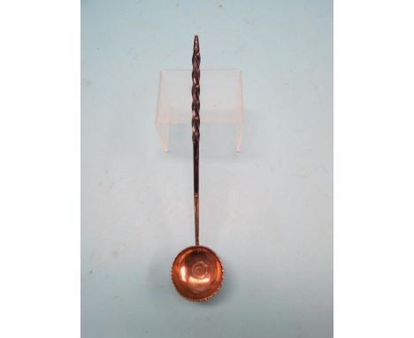 A George III white metal toddy ladle, with twisted whalebone handle and inset coin, 1768 SEE ILLUSTRATION