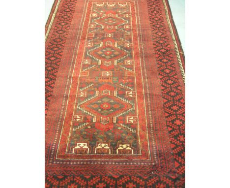 An Eastern wool rug, lozenge designs predominantly in red, black and cream, 7ft. 6in. x 3ft. 4in., and a Turkish wool runner,