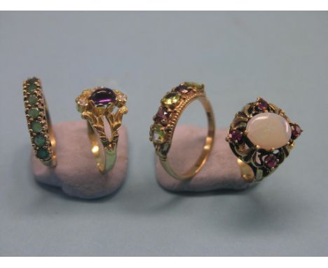 A 14ct. gold amethyst and diamond ring, 9ct. gold amethyst and peridot half-hoop ring, 14ct. gold opal and ruby ring, and a 1