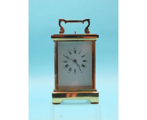 A French brass carriage clock with repeat, enamelled Roman dial and gong-striking movement, with key, 7.25in.