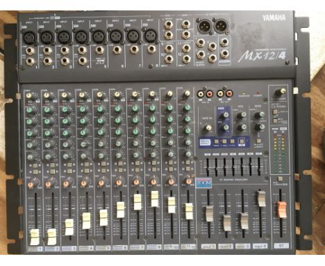 A Yamaha MX12/4 mixing console with instructions.