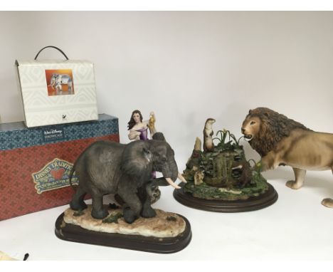 A Swarovski Crystal elephant in a box a Disney Showcase set in a fitted box elephants and a ceramic lion (a lot)