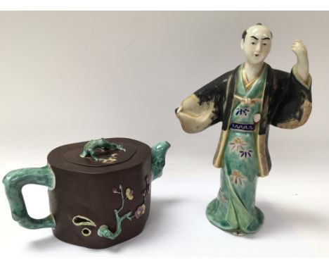 A Ji - Xing terracotta teapot, and a Chinese figure.