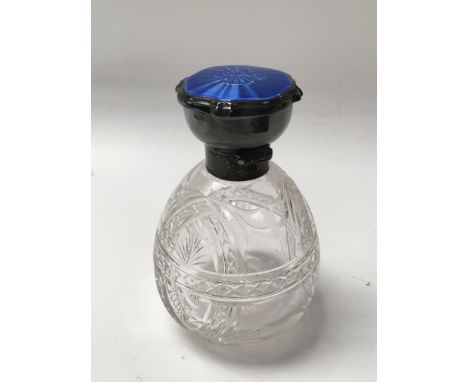 A silver and enamel necked glass scent bottle.