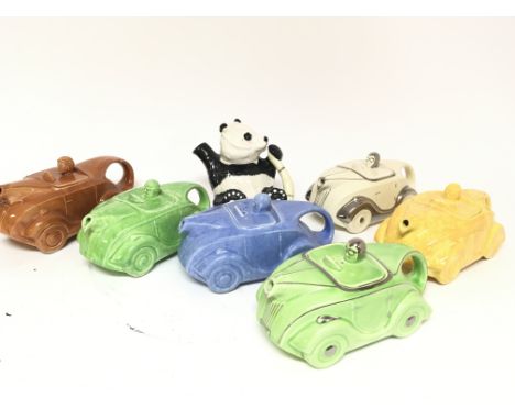 A collection of saddlers British made ceramic teapots in the form of racing cars in various colours and a Beswick novelty tea