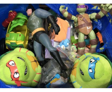 A bag of various toys including a Batman figure, Teenage Mutant Hero turtle soft toys, carebear figures etc - NO RESERVE