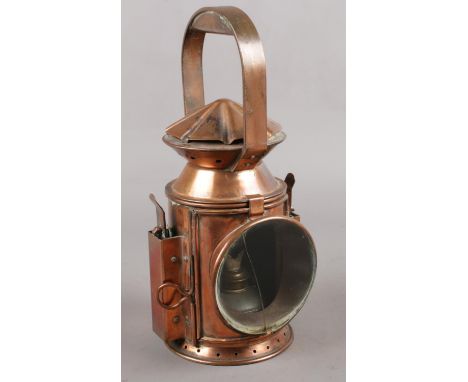 A G.P LTD 1951 copper military railway lamp, baring the broad arrow mark.  Glass cracked.