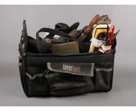 A tool bag with a small selection of tools to include, a wood saw, 'Sky Tronic' Digital Multimeter 600.006 with instructions 