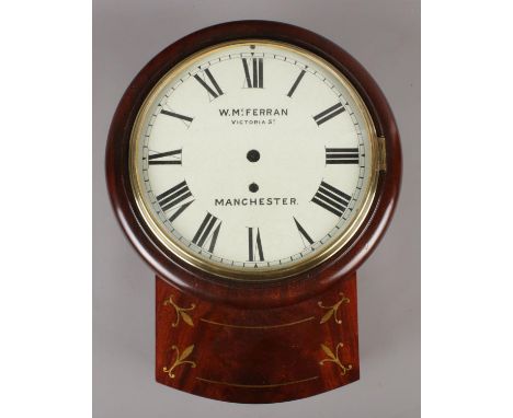 A W.Mc. Ferran mahogany drop dial wall clock case with brass inlay decoration and enamel dial. (Diameter of brass bezel 23cm)