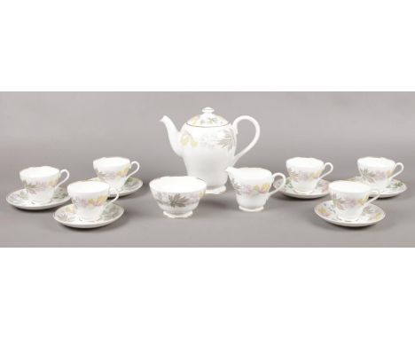 A Shelley ' Columbine' coffee set, 6 coffee cups/saucers, coffee pot, sugar bowl, milk jug  chips on two saucers, two cracks 