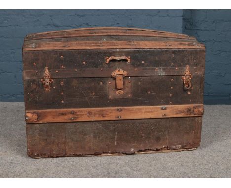 A Wood and Metal Bound Dome Topped Travelling Trunk. H-54cm, W-77cm, D-43cm.  Please note that there is damage to the bottom 