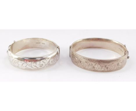 A Georg Jensen silver bangle, with engraved decoration, on a snap clasp, together with another similar English silver bangle,