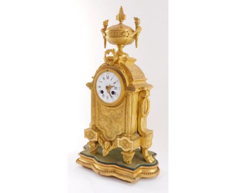 A French late 19thC Louis XVI style gilt metal cased mantel clock, circular enamel dial bearing Roman and Arabic numerals, ei