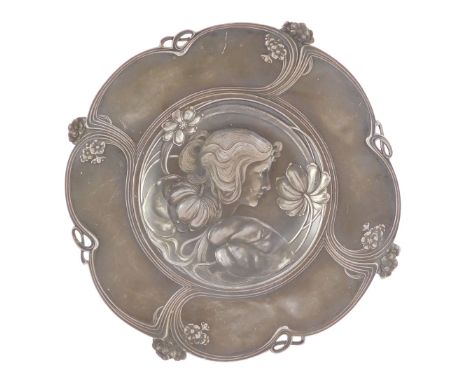 An Art Nouveau late 19thC pewter circular dish, pierced and embossed with a bust portrait of a lady, flowers and sinuous scro