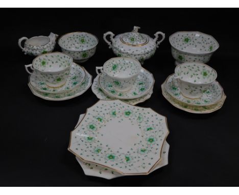 An early 19thC porcelain part tea service, decorated in green and yellow with flowers, within gilt rings, pattern no 21, pain