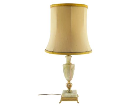 An onyx and brass table lamp, of baluster vase shape form, raised on a square base, with shade, 63cm high.