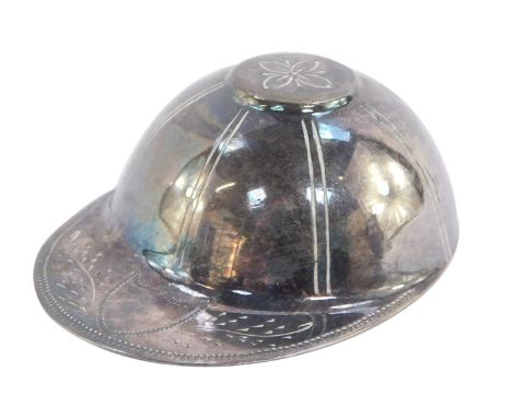 A silver caddy spoon modelled as a jockey's cap, London 1976, 0.5oz.