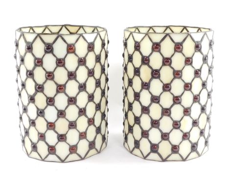 A pair of Tiffany style cylindrical lamp shades, decorated with lattice work and red cabochons, 22.5cm high. 