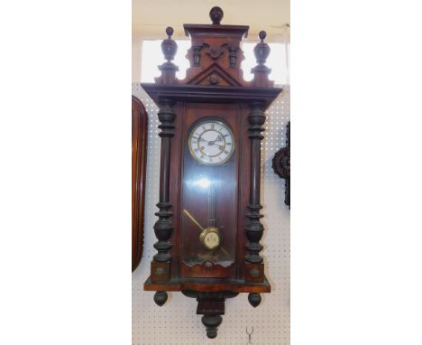 A Continental late 19th Century walnut cased wall clock, brass and enamel dial bearing Roman numerals, eight day movement wit