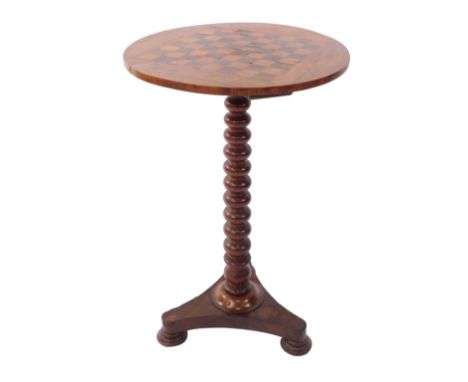 A Victorian specimen wood games table, the circular top inlaid with a rosewood and satin wood chess board, above a bobbin tur