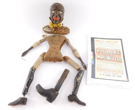 A Victorian marionette of a black gentleman, carved in wood, the torso marked in ink "K Barnard, Bullock's Royal Marrionettes
