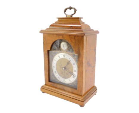 An Elliott mid century walnut cased mantel clock, break arch tempus fugit dial, with chapter ring bearing Roman numerals, clo