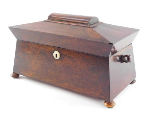 A Regency rosewood tea caddy, of sarcophagus form, the hinged lid opening to reveal a central recess flanked by two canisters