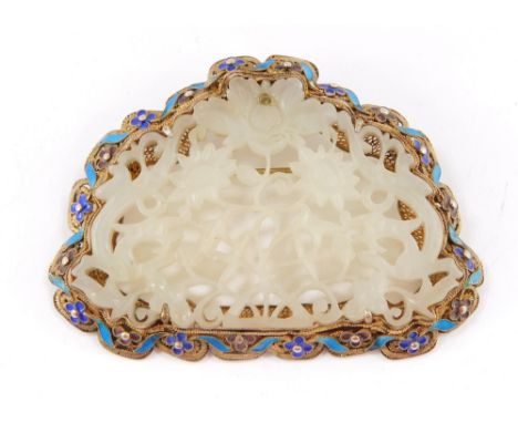 A Chinese white jade silver filigree and champleve enamel pendant brooch, carved and pierced with flowers, in a frame decorat