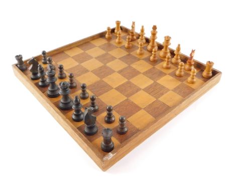 A Staunton chess set, together with a chess board. 