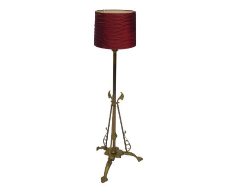 A Regency style brass standard lamp, the column with three scrolling acanthus leaf supports, raised on a floral base and thre