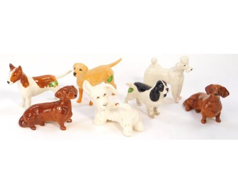 Seven Beswick pottery terriers, spaniels, and other dogs.