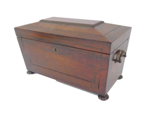 A Regency rosewood sarcophagus tea caddy, with a pair of carrying handles, brass strung, the lid opening to reveal two compar
