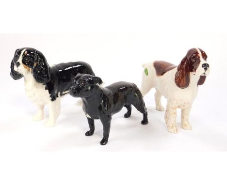 A Beswick figure of a King Charles spaniel, a springer spaniel, and a Royal Doulton figure of a Staffordshire terrier. (3).