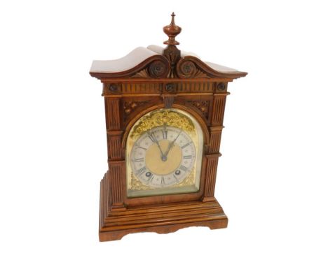 A Victorian walnut cased mantel clock, the domed dial with gilt rococo floral and foliate scroll spandrels, silvered chapter 