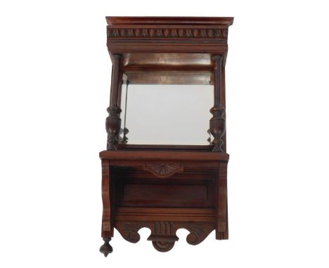 A Victorian mahogany wall mirror, with a shaped pediment over a single shelf, above a rectangular bevelled glass mirror front